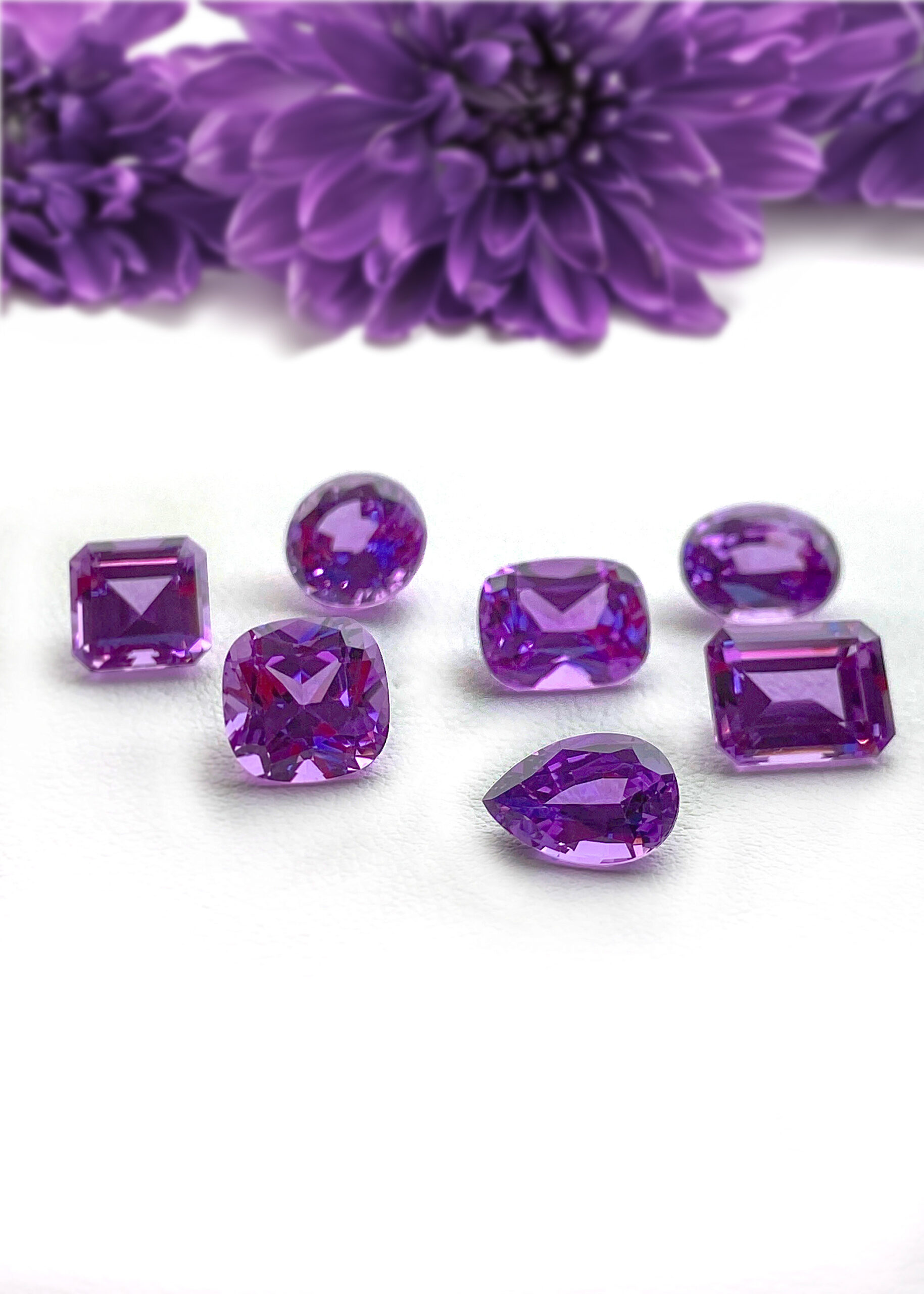 Chatham lab grown purple sapphire gemstones with purple flowers