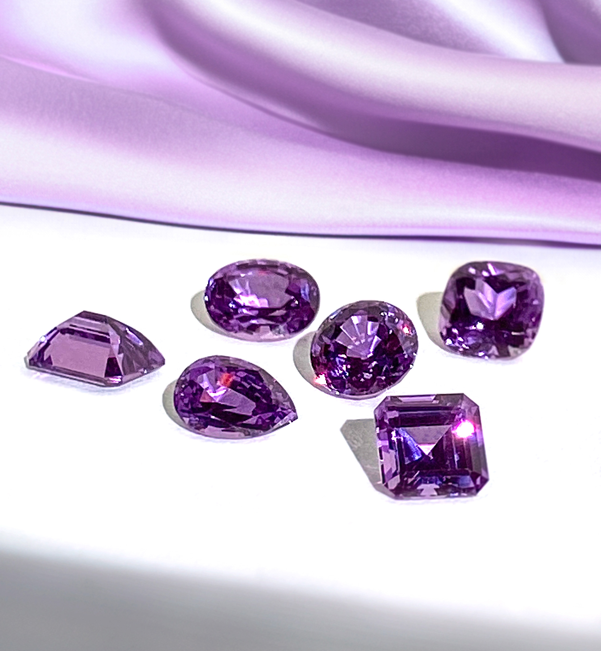 Chatham lab grown purple sapphire gemstones with purple silk